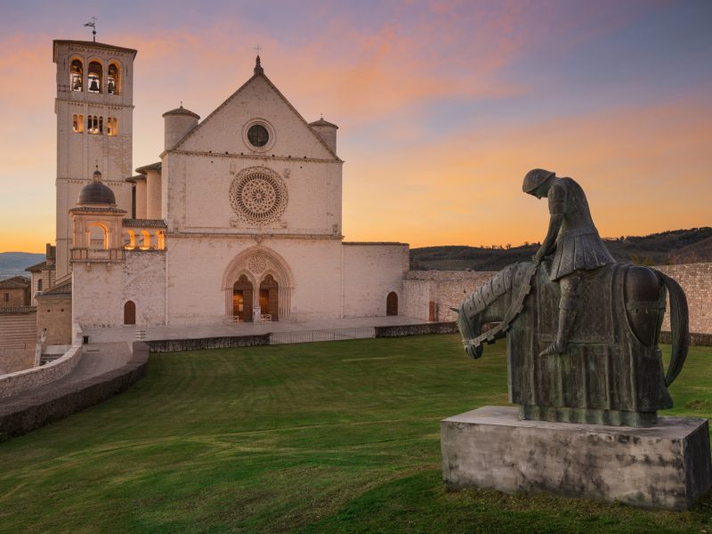 Assisi, Italy with the Basilica of Saint Francis of Assisi at dusk.
